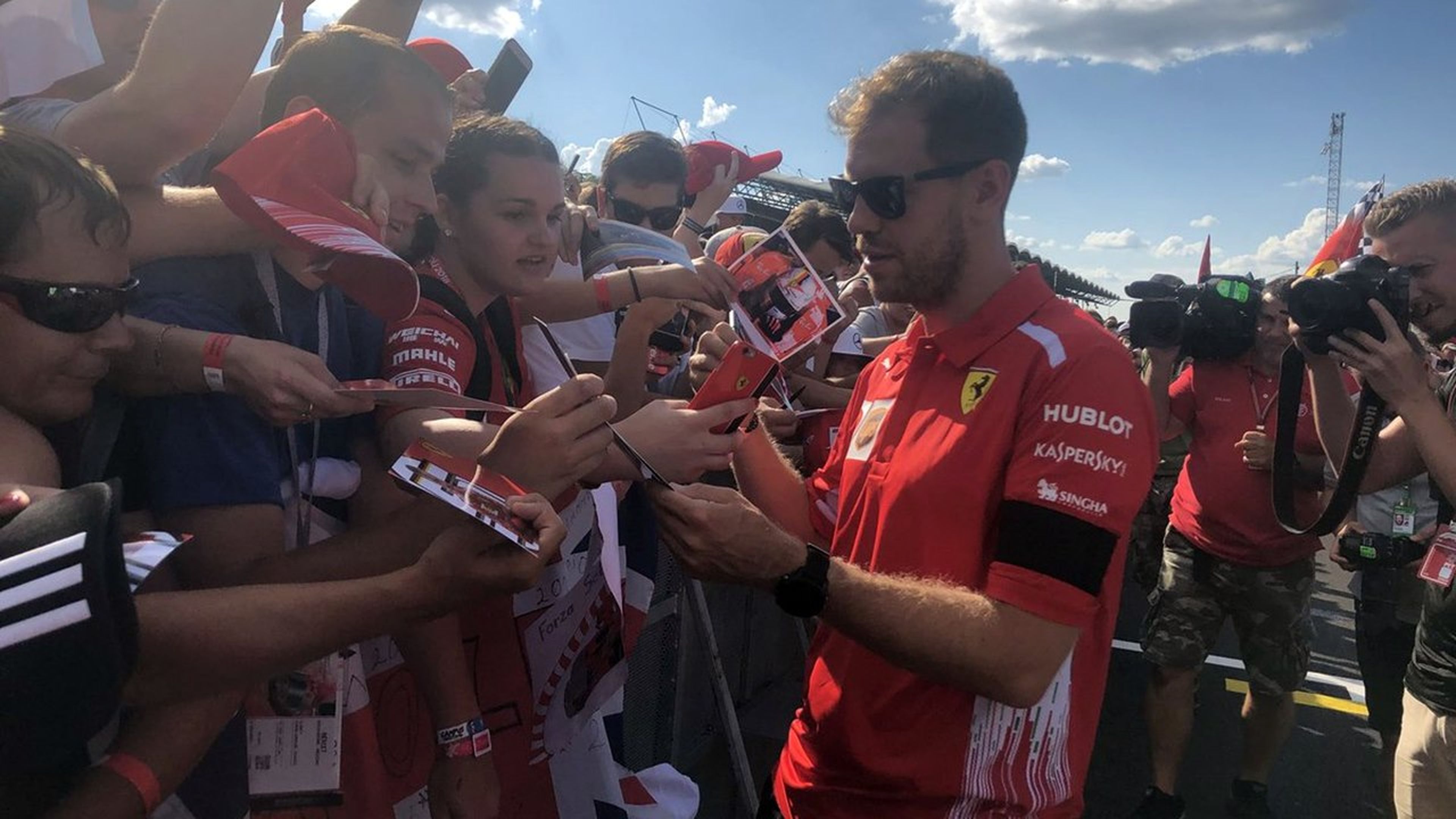 Vettel firma autógrafos