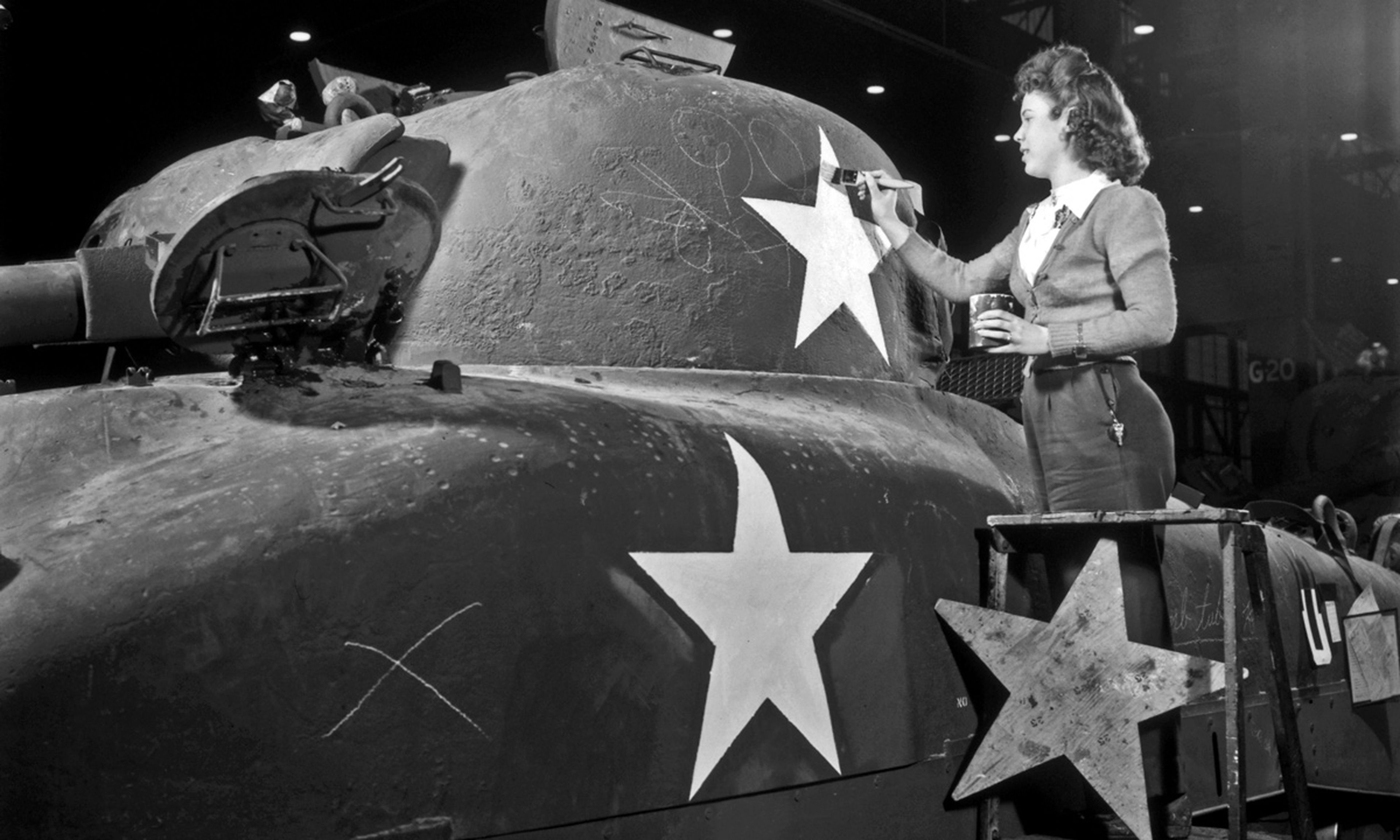 Una mujer pinta la torreta de un tanque producido por GM en 1944.